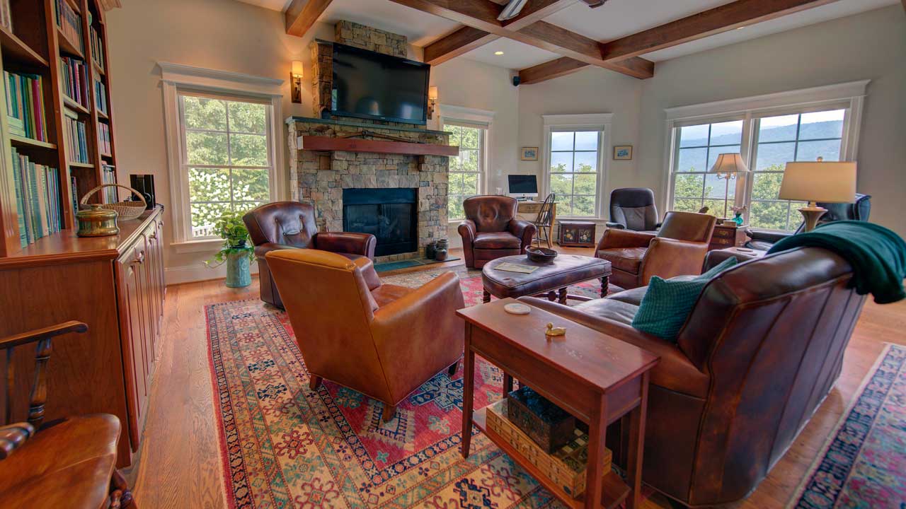 121 Lexington Ct living room with stone fireplace, beams and beautiful views